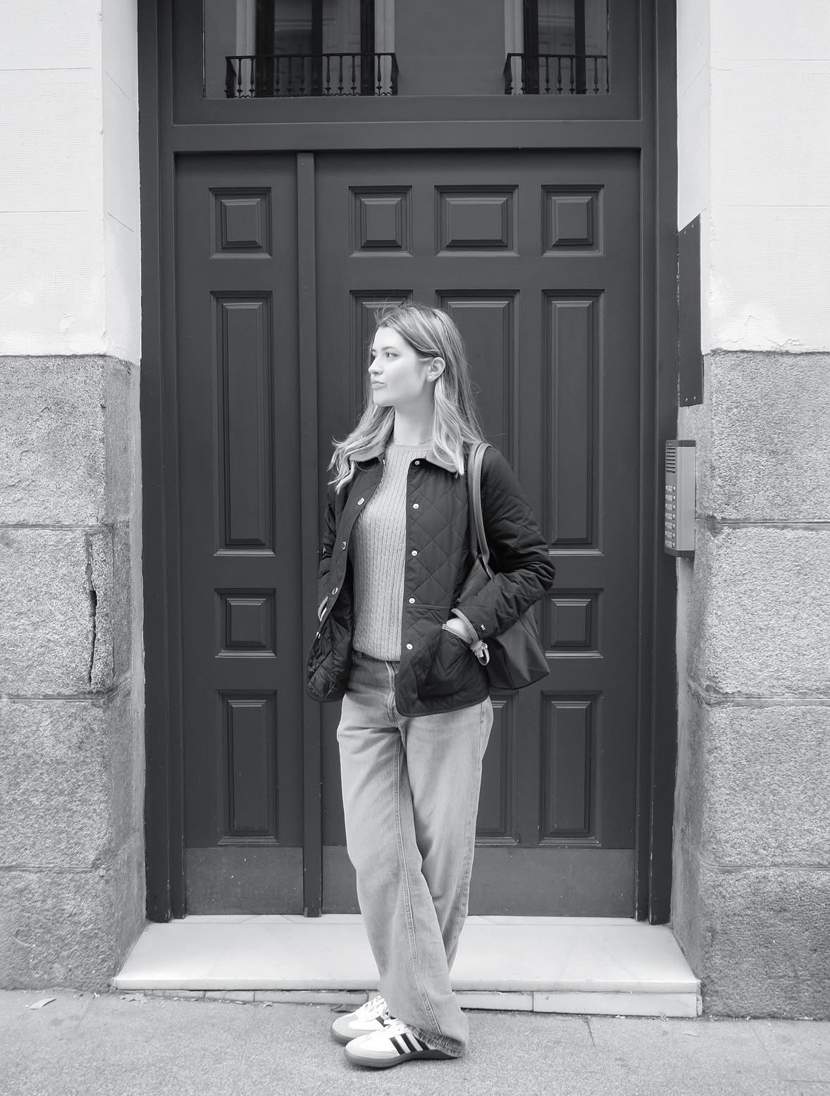 Picture of Nadia posing in front of a cool-looking door, looking sideways